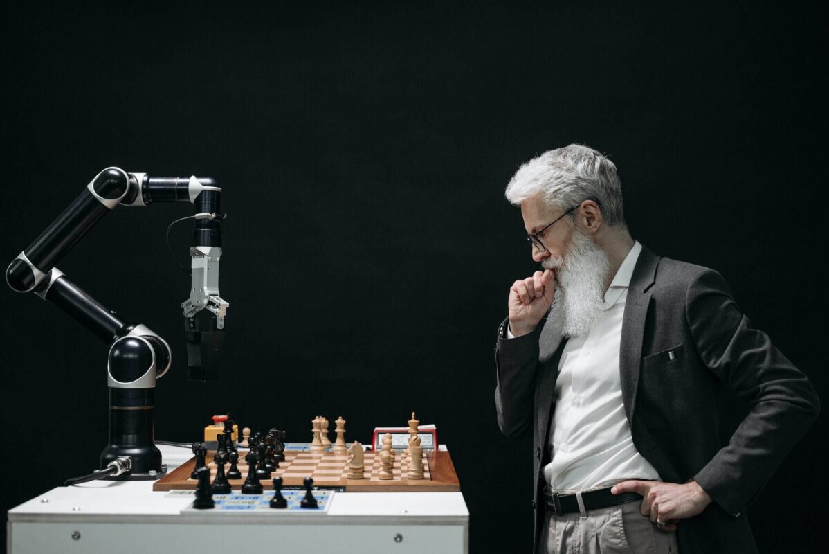 A man playing chess with a robot